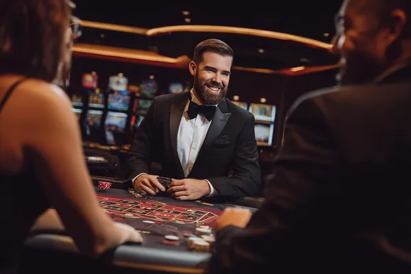 A young woman relaxing with her phone while dynamic casino elements float around her, illustrating the smooth mobile experience offered by the MALIWIN app.