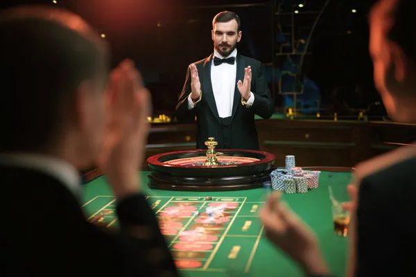 A glamorous woman holding casino chips in a neon-lit environment, representing the premium online casino atmosphere of MALIWIN.