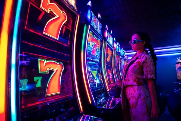 A person using their device against a moody casino-themed background, illustrating the smooth re-entry process at MALIWIN.
